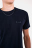 Close up on MILLO logo on MANON t-shirt.
